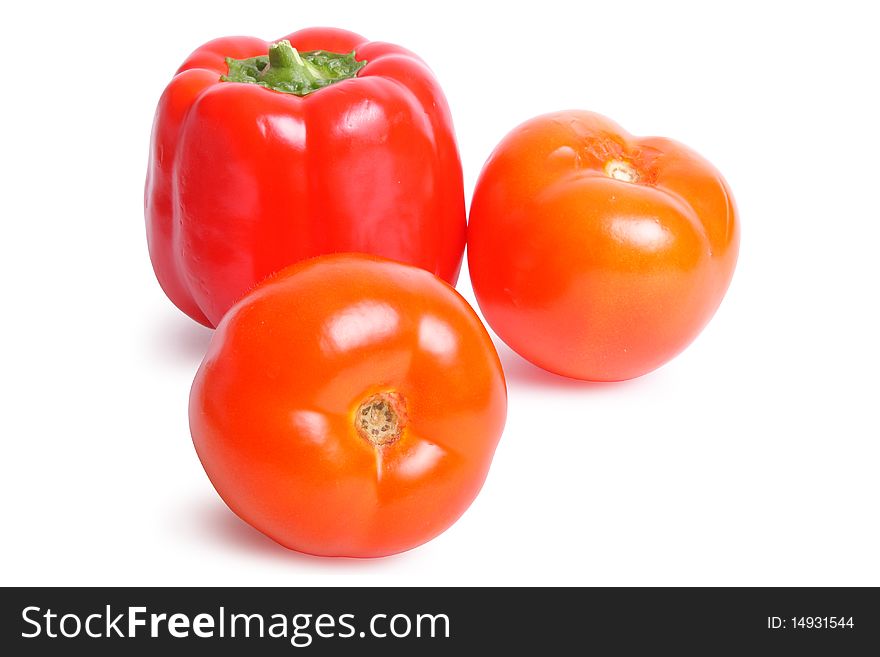 Tomato and pepper on white