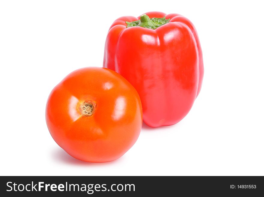 Tomato and pepper on white