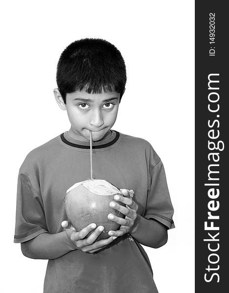 An handsome Indian kid drinking coconut water to cool off