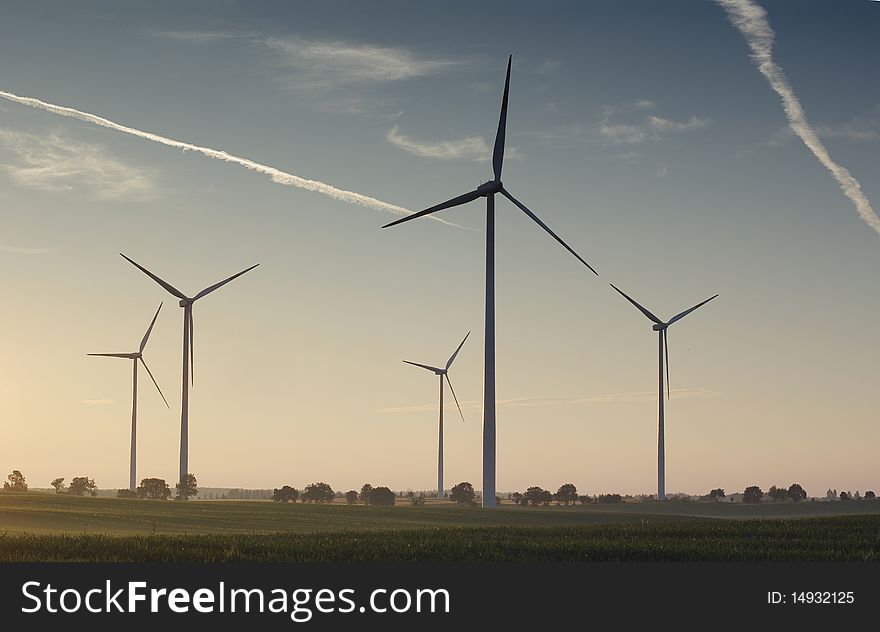 Wind turbine on sunset background