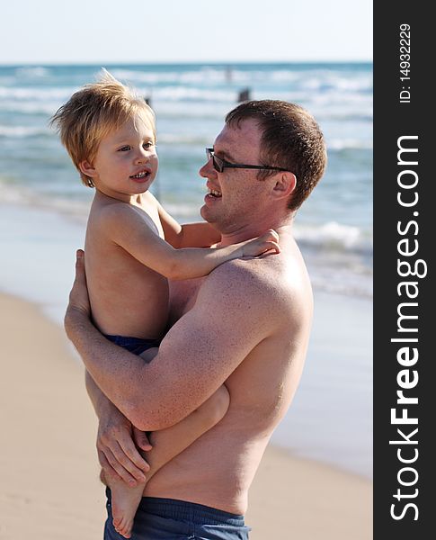 Father at the beach with his child. Father at the beach with his child