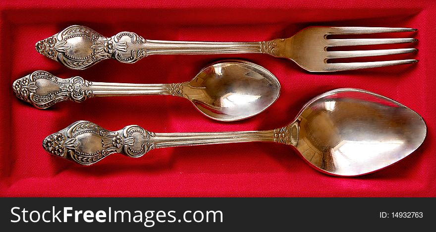 Silver tablewares on red background