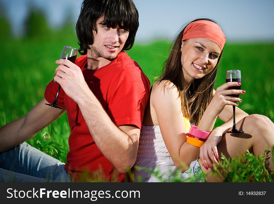 Boy with beautiful girl and with wineglasses on grass. Boy with beautiful girl and with wineglasses on grass