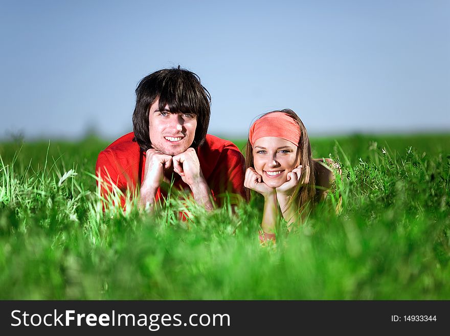 Smiling girl and boy on grass