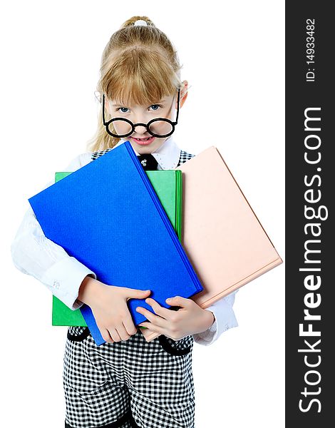 Shot of a little girl in glasses standing with books. Isolated over white background. Shot of a little girl in glasses standing with books. Isolated over white background.