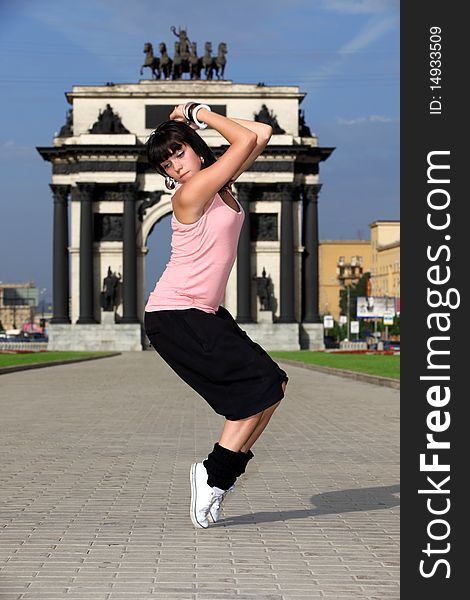Woman modern ballet dancer in city against classic arch