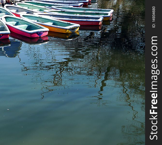 Boats on a pond in a park in Tokyo. Taken on a sunny Saturday.