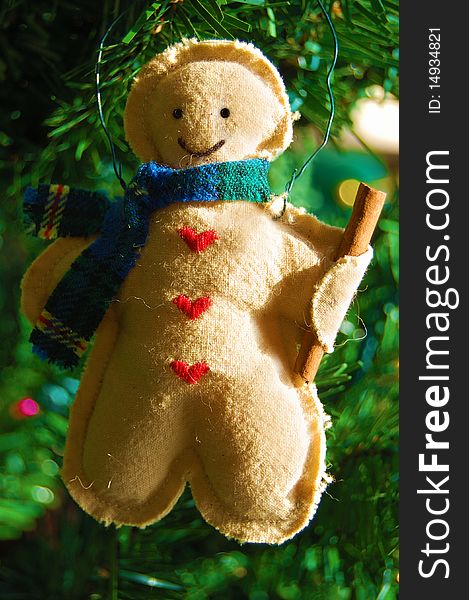 Cute Christmas figure ornament with a s scarf and cinnamon stick. Cute Christmas figure ornament with a s scarf and cinnamon stick