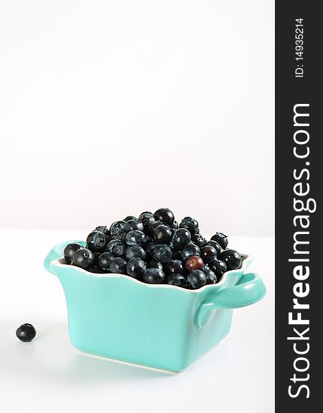Shot of fresh blueberries in blue bowl vertical