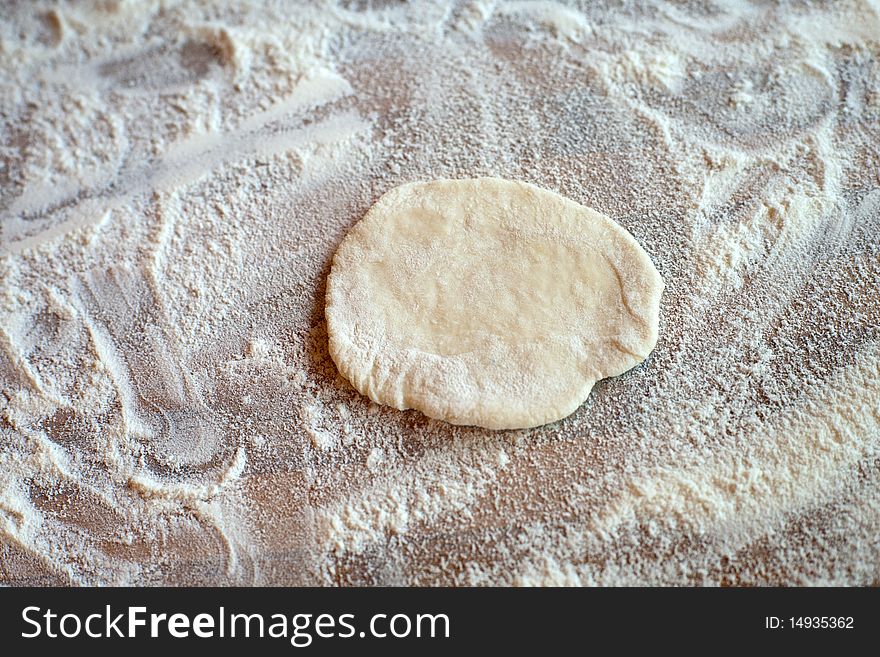 An image of a piece of dough on the table