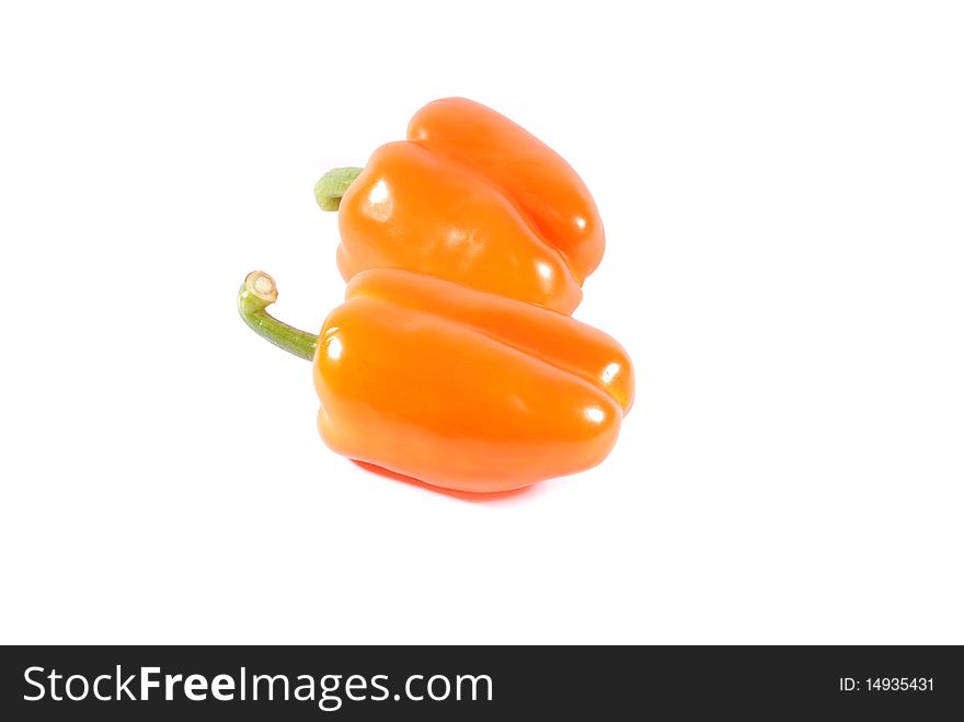 Two orange sweet peppers isolated over white background