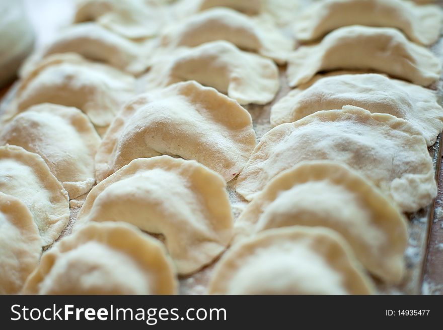 An image of raw dumplings on the board