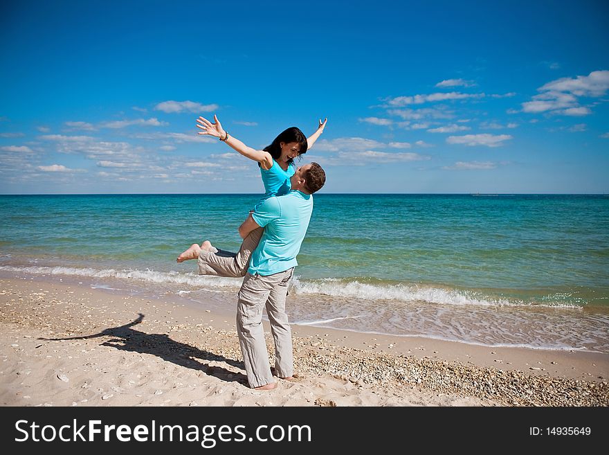 A couple on beach have fun