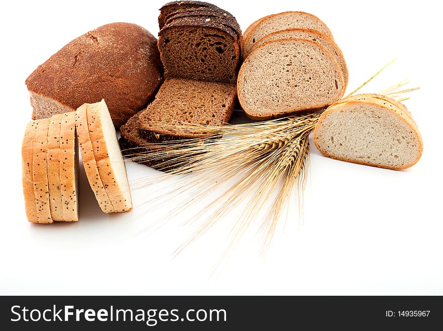 Various sorts of bread and spikes on white background. Various sorts of bread and spikes on white background