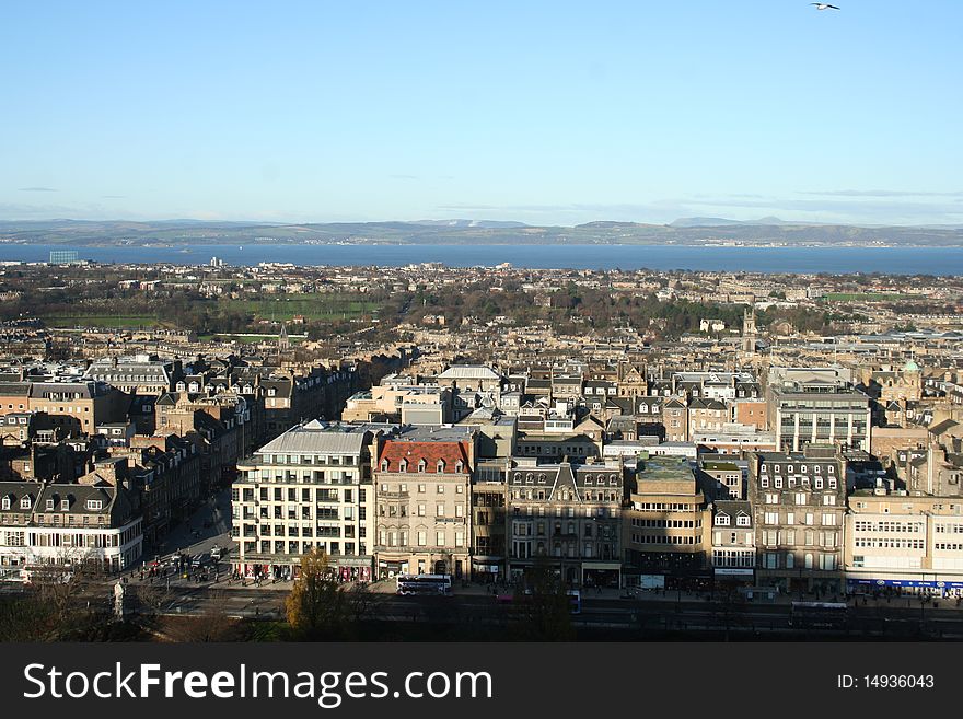 Taken from Edinburgh Castle this photograph looks North over Edinburgh and out to the sea. Taken on St. Andrews Day (November 30th) 2009, the patron saint of Scotland. Wonderful view of Prince's Street, the shadow from the Castle and the beautiful architecture. Taken from Edinburgh Castle this photograph looks North over Edinburgh and out to the sea. Taken on St. Andrews Day (November 30th) 2009, the patron saint of Scotland. Wonderful view of Prince's Street, the shadow from the Castle and the beautiful architecture.