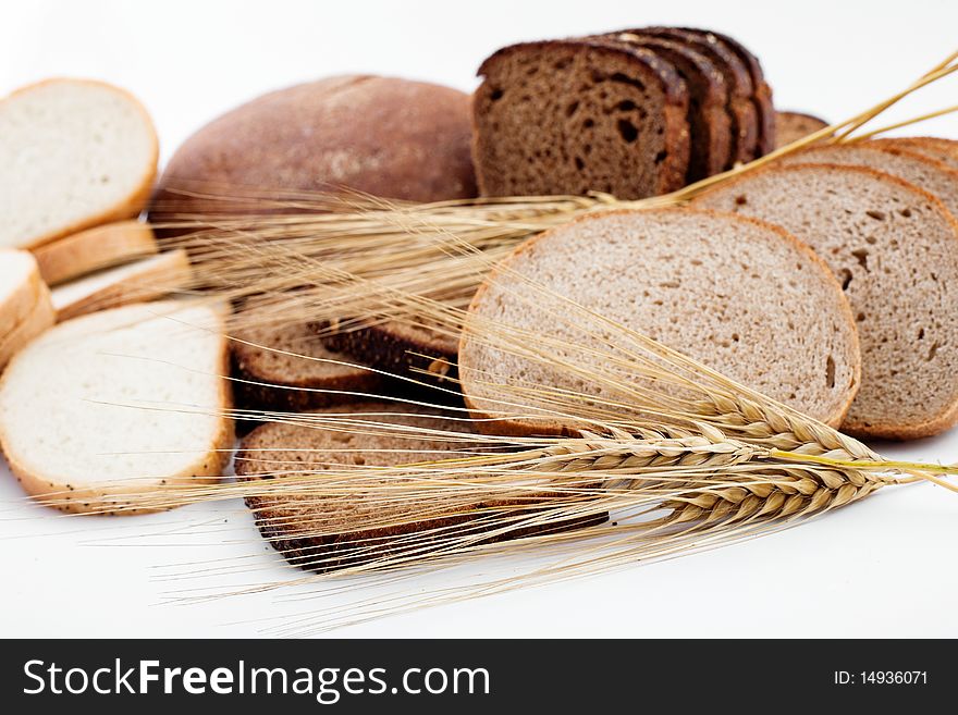 Various sorts of bread and spikes on white background