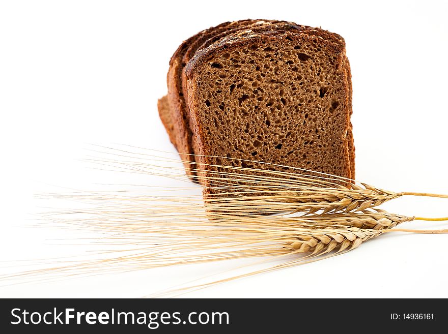 Various sorts of bread and spikes on white background. Various sorts of bread and spikes on white background