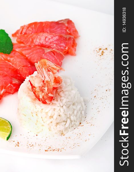 Rice with prawn and salmon on white plate. Rice with prawn and salmon on white plate