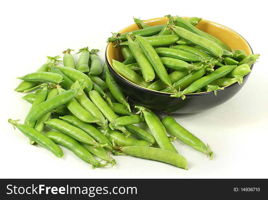 Delicious fresh green peas on white