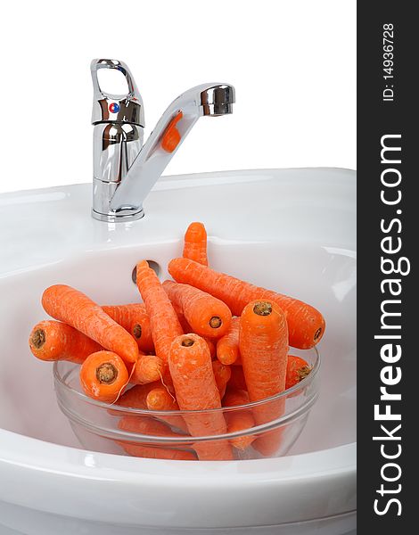 Washed carrots in a white Sink. White background