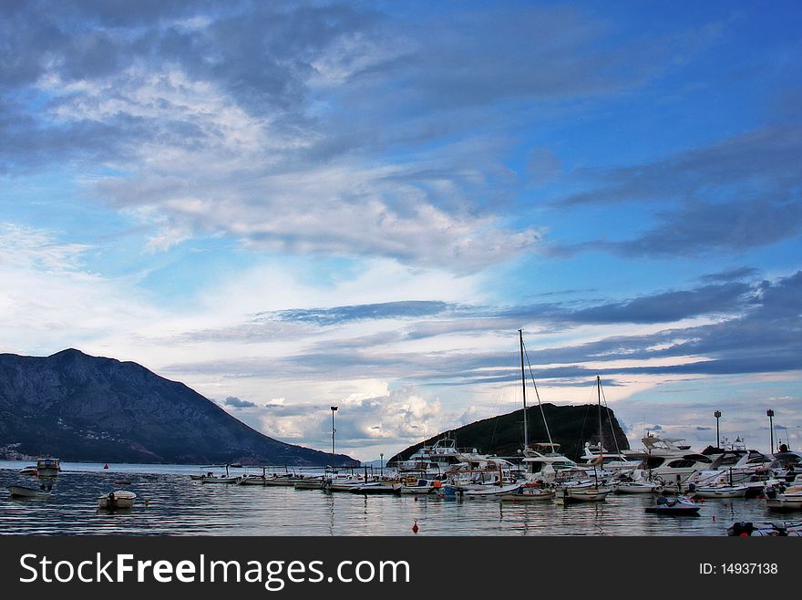 Boats and yachts moored in harbor at sunset. Boats and yachts moored in harbor at sunset.