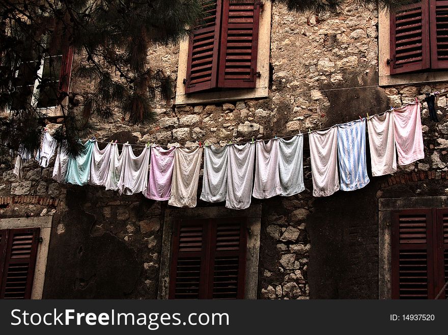 Towels on a linen against an old wall of the house. Towels on a linen against an old wall of the house.