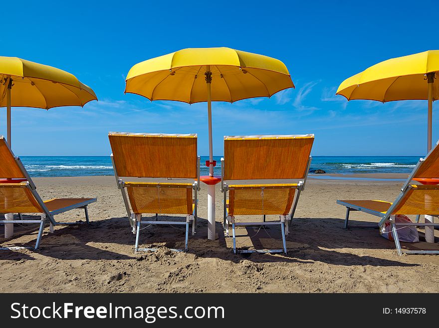 Lounge chairs under a yellow