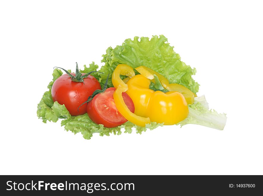 Sliced sweet pepper and tomatoes lying on green lettuce. Isolated on white background with clipping path. Sliced sweet pepper and tomatoes lying on green lettuce. Isolated on white background with clipping path