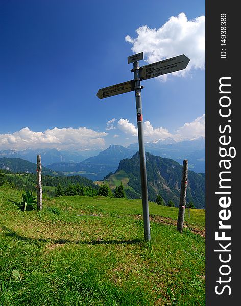 Signpost in the Alps along an Alpine trail. Signpost in the Alps along an Alpine trail