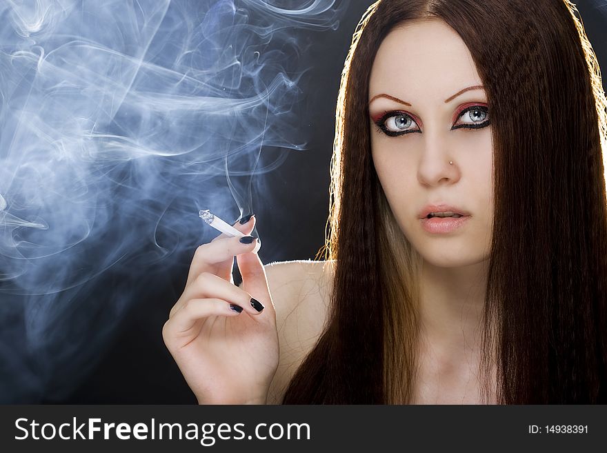 Portrait of the beautiful young woman with a cigarette. Portrait of the beautiful young woman with a cigarette