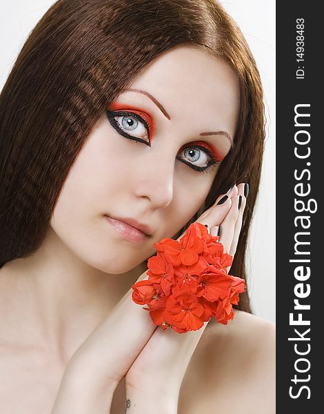 Close-up beautiful woman with bright make-up holding flower. Close-up beautiful woman with bright make-up holding flower