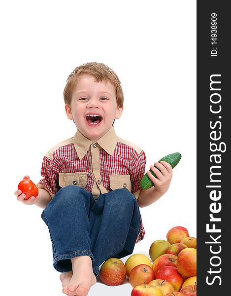 The little boy with fruit and vegetables isolated on white