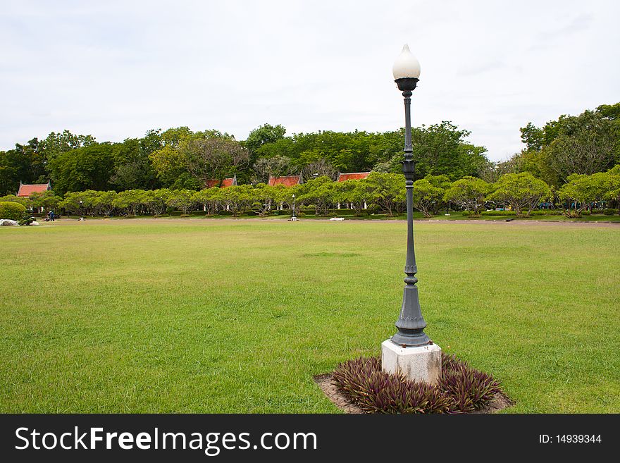 Lamp and the sidewalk in the park,green grass in the yard. Lamp and the sidewalk in the park,green grass in the yard