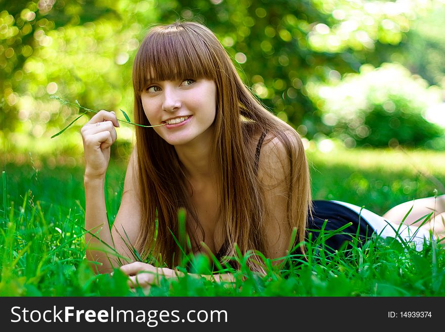 Portrait of the young girl on a lawn. Portrait of the young girl on a lawn.