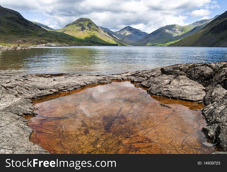 A rusty pool by a lake in the Lake District, England. A rusty pool by a lake in the Lake District, England.