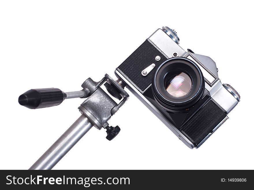 Old camera on monopod isolated on a white background