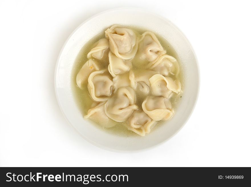 Ravioli in plate close-up on white background