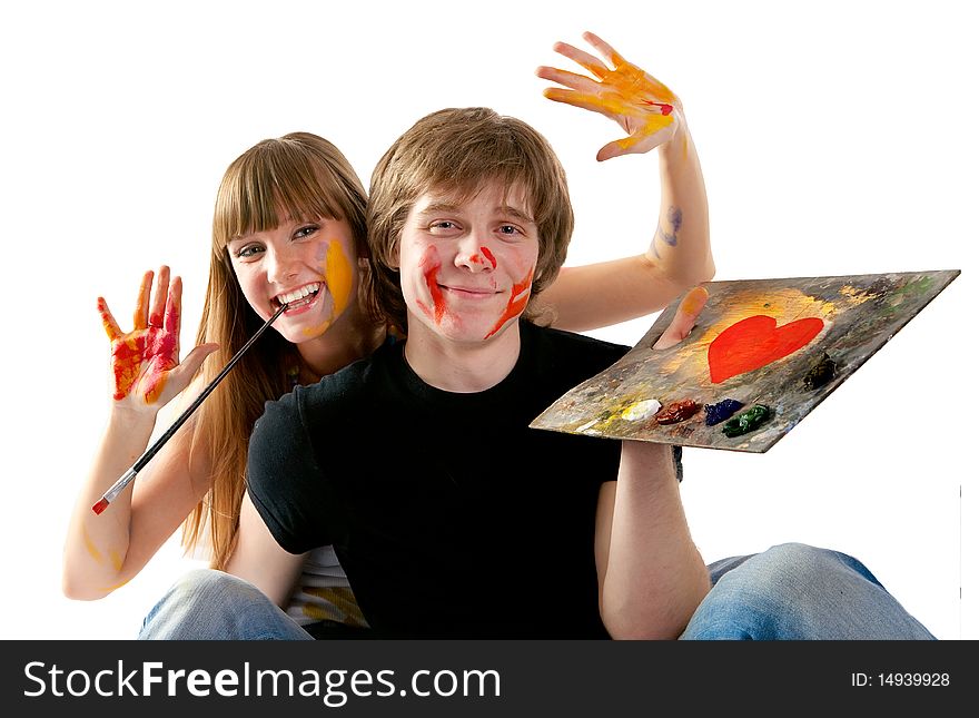 Young couple playing with painting isolated on  white