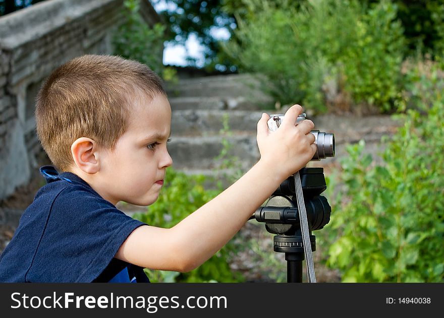 Little boy looks into focus the camera lens. Little boy looks into focus the camera lens