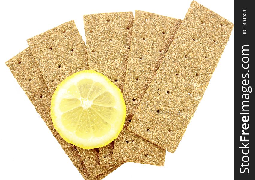 Crackling bread is spread out in the form of a fan, and on it the lemon segment lies. Crackling bread is spread out in the form of a fan, and on it the lemon segment lies