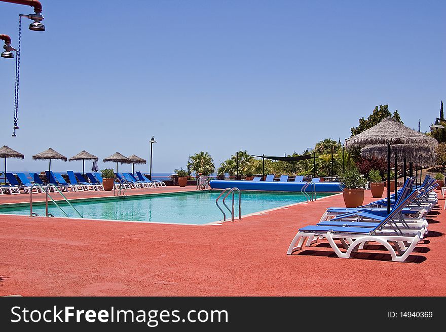 Empty swimming pool with sunbeds. Empty swimming pool with sunbeds