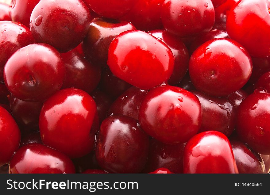 Background from lying berries of cherries, perfused water.