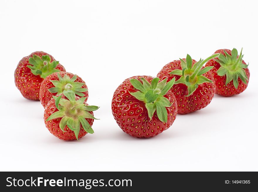 Six ripe, freshly picked strawberries arranged in two rows. Six ripe, freshly picked strawberries arranged in two rows.