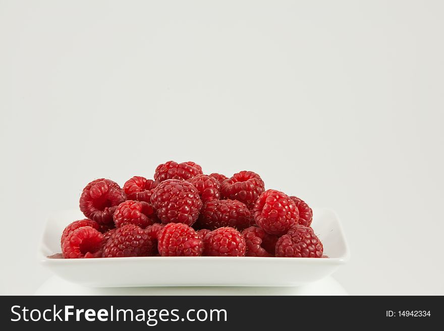 Closeup of fresh raspberries on white background