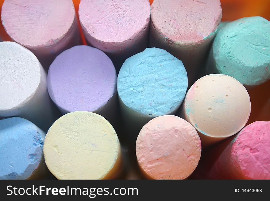 Closeup of pastel colored chalk used by children for coloring on concrete sidewalks. Closeup of pastel colored chalk used by children for coloring on concrete sidewalks.