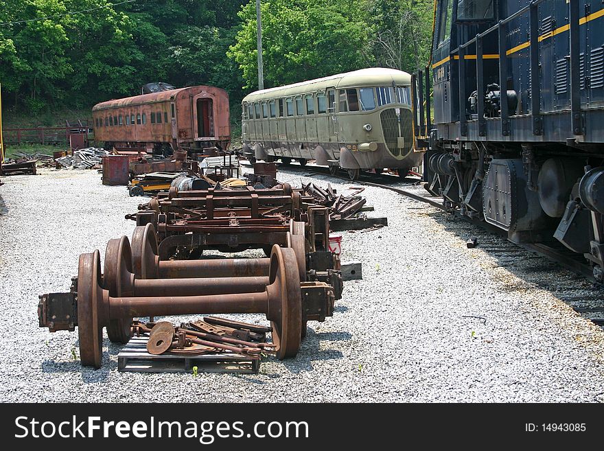 Old trains and train parts in a railroad maintenance yard. Old trains and train parts in a railroad maintenance yard