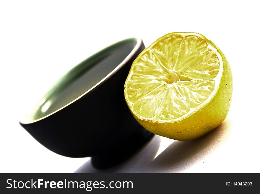 Cup of green tea with half a lemmon. close up, background