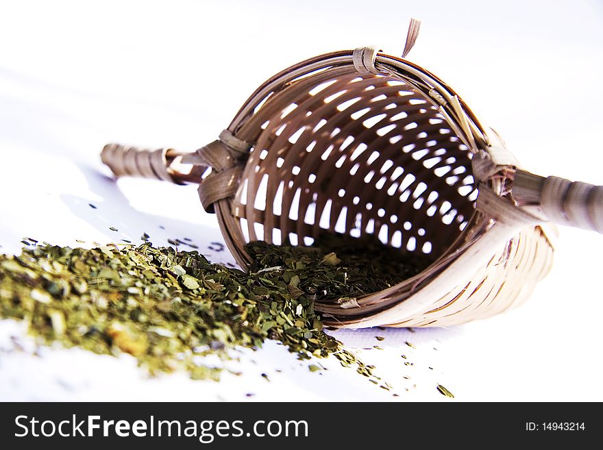 Bamboo tea strainer whith green tea studio shot. Bamboo tea strainer whith green tea studio shot