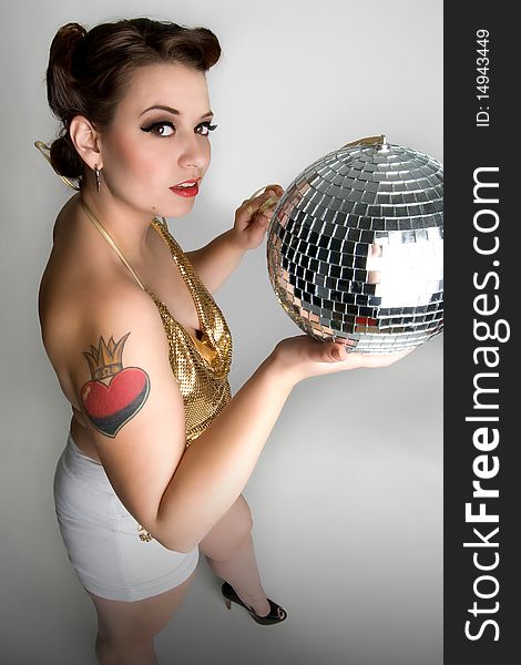 Sexy girl holding mirrored disco ball. Sexy girl holding mirrored disco ball