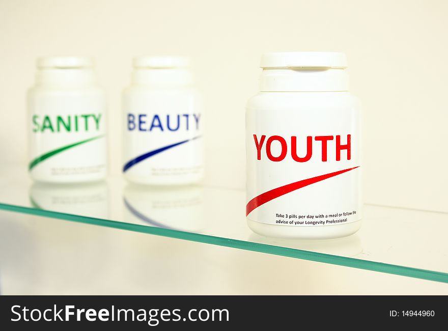 Sanity, Beauty and Youth pills in a bottle on bathroom shelf with focus on Youth, fake brands